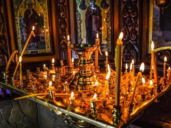 Velas encendidas en un stand cerca de los iconos de la capilla . — Foto de Stock