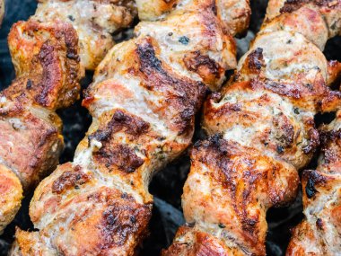 Brezilya şiş üzerinde domuz kızartması yemek. Kömürün üstünde et çeviriyorum..