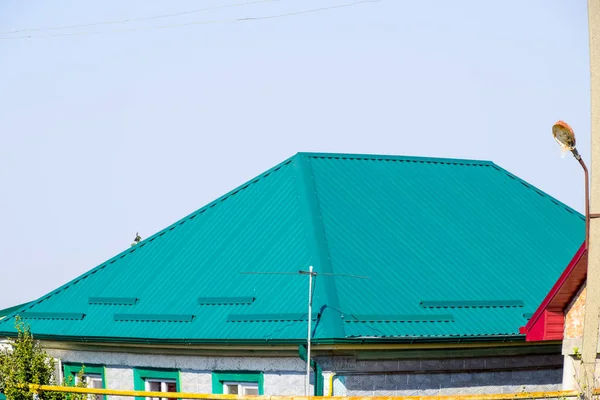 stock image Green metal profile corrugated roofing on the house.