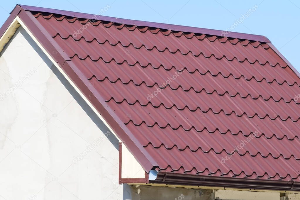 The roof of corrugated sheet. Brown corrugated metal profile roo