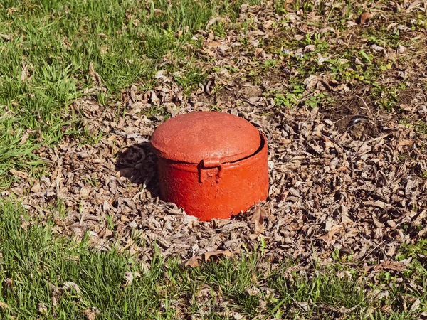 Hatch steel, red color. in park there is a sewerage. — Stock Photo, Image