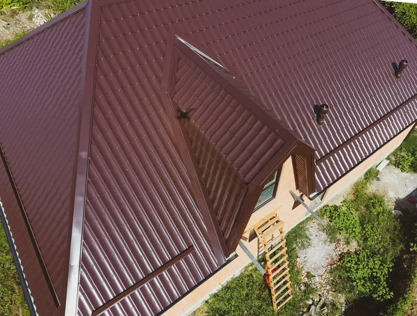 A view from above on the roof of the house. The roof of corrugated sheet. Roofing of metal profile wavy shape — Stock Photo, Image