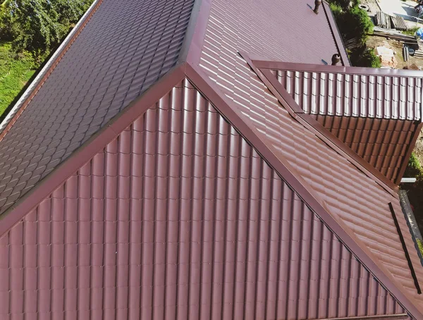 A view from above on the roof of the house. The roof of corrugated sheet. Roofing of metal profile wavy shape — Stock Photo, Image