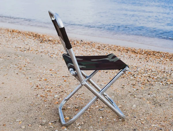Folding chair by the sea. Convenience to the tourist. Rest by the sea.
