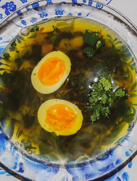 Soup with boiled egg and parsley