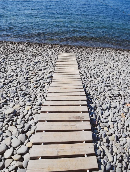 Wooden path to the sea. Flooring of planks on the path to the sea