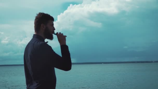 Jovem homem elegante fumar cigarro eletrônico — Vídeo de Stock