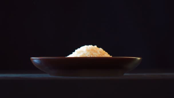 Pouring rice into plate shooting with high speed camera — Stock Video