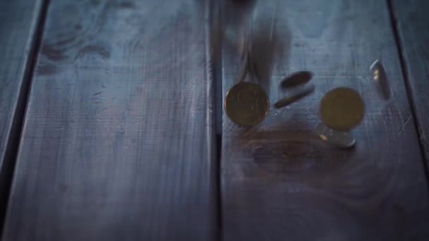 Pile of coins falling on the wooden table — Stock Video