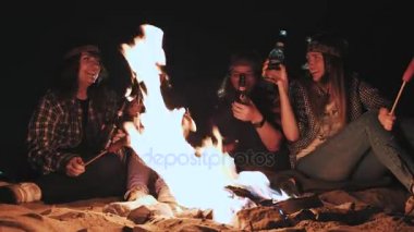 Genç çift, içecek içme ve gece orman yangın yakındaki kodes gözlük yapıyor severler alkol ve açık havada cam toasting yapar, kız adamla seyahat Kampı'nda woodland bira Şerefe.
