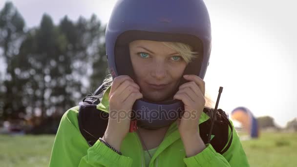 Porträt eines schönen Gleitschirmmmädchens, blond mit blauen Augen. nimmt er seinen Helm ab. Indigo-Kinder. — Stockvideo