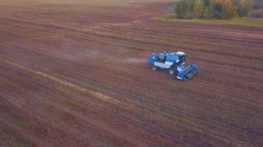 Gün batımında tarlada çalışan bir hasatçının insansız hava aracı görüntüsü..