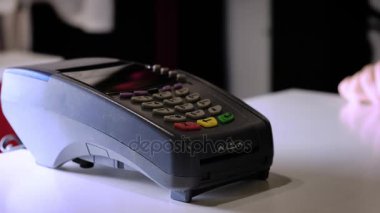 Bir kız ile bir banka veya kredi kartı bir elektronik çip kartı kullanarak bir satın alma işlemi yaptığı. Sigara nakit terminal bir kart takın.