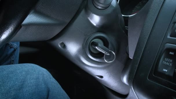 Starting car engine. a mans hand drives a car key. — Stock Video