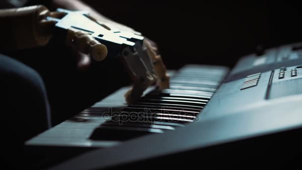 Man musician pianist with a prosthetic hand playing the piano. He plays with two hands, a robot hand and a human hand. Robot creates music and art — Stock Video