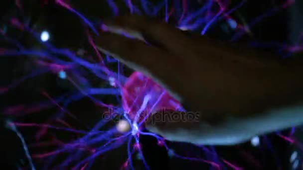 Abstract lightning in a plasma balloon. A man touches his hand to electricity. Transmission of electrical energy through the air, wireless transmission of electricity. — Stock Video