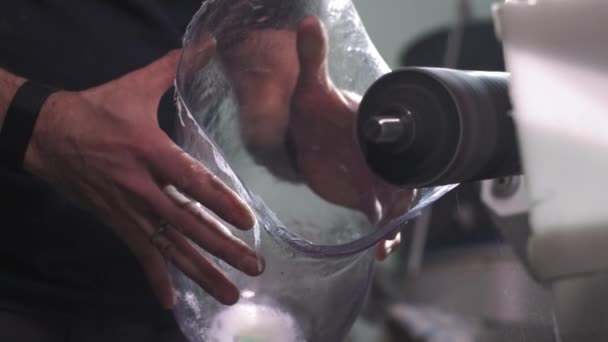 Production of a prosthetic leg. A man creates a part of the leg above the knee. Grinds the plastic part of the leg on a lathe. New body part — Stock Video