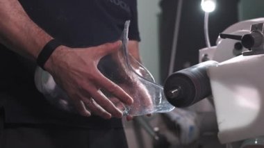 Protez bacak üretimi. Bir adam dizinin üstünde bacağın bir parçasını yaratır. Torna tezgahında bacağın plastik kısmını öğütüyor. Yeni gövde parçası