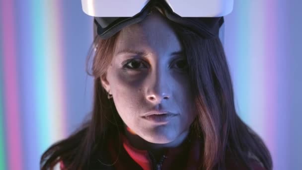 Girl is a professional gamer in virtual reality glasses. Immersed in a parallel reality, creates architectural objects. Futuristic white VR glasses. The designer creates new art — Stock Video