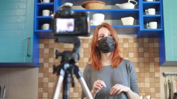 Chica bloguera de comida influencer está grabando un video o podcast. Te enseña a usar mascarillas médicas. Bloggers against coronavirus and pandemic. La epidemia del virus chino en Internet — Vídeos de Stock