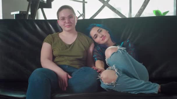 Portrait of lesbian couple looking into the camera. Two happy girlfriends. A girl with colored hair and a bald woman hold hands. Free same-sex love. Homosexual relationship. LGBT Community Pride. — Stock Video