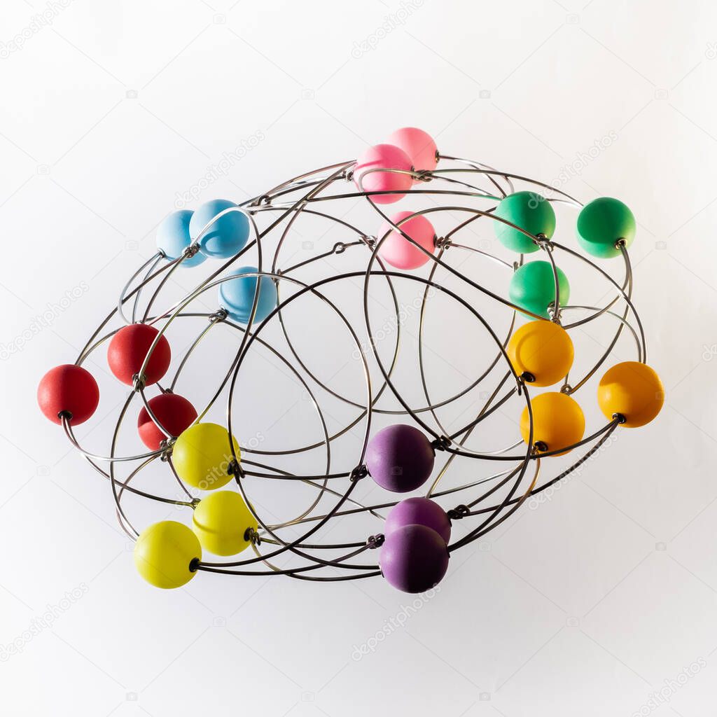 Multicolored handmade three-dimensional model of geometric solid on a white background.