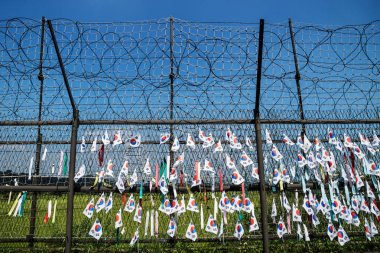 Fence with barbed wire and south korean flags at the demilitarised zone DMZ at the freedom bridge, South Korea, Asia clipart