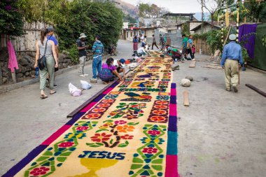 Alfombra yapan yerli halk, İsa ile talaş halıları ve Semana Noel Baba için çiçekler San Marcos La Laguna, Lago de Atitlan, Guatemala sokaklarında Paskalya