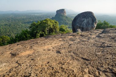 Big Stone on Pidurangala Rock with view on Lions Rock in Sigiriya, Sri Lanka