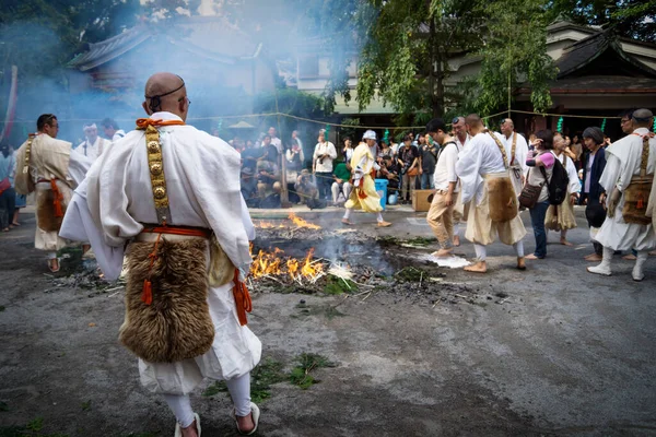 Visitatore che cammina sul fuoco con l'aiuto dei monaci al tempio di Honsen-ji durante il Shinagawa Shukuba Matsuri Festival a Tokyo, Giappone — Foto Stock