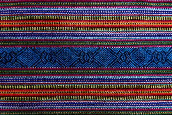 Detail of a traditional Mayan Guatemalan woven colorful fabric with crosses and stripes