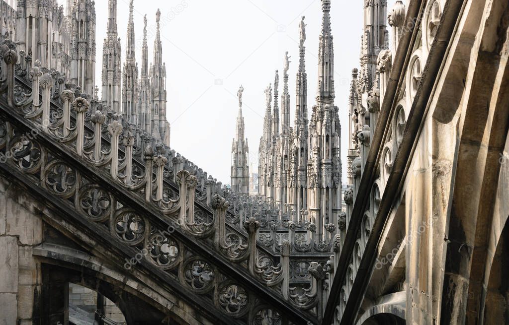 Rows of sunlit gothic towers of the Cathedral of Milan, Italy