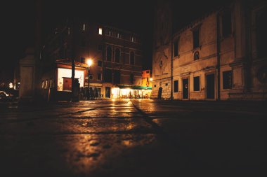 Venedik, İtalya 'da bir restoranın aydınlık emty teraslı karanlık gece sokakları