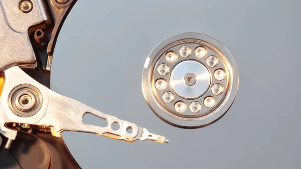 Disassembled hard drive from the computer, hdd with mirror effect. Opened hard drive from the computer hdd with mirror effects. Part of computer pc, laptop