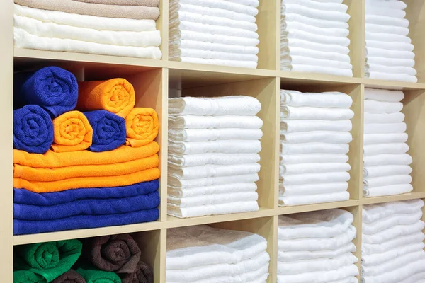 Fresh White Hotel Towels Folded and Stacked on a Shelf