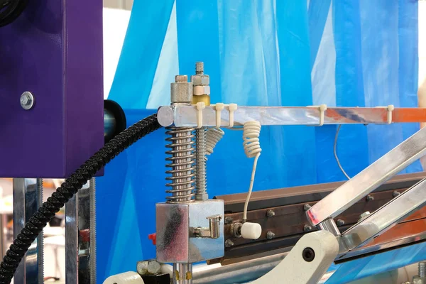 The operation of automatic plastic bag production machine. Close-up of the roller of the polyethylene bag production machine.  machine for packaging with cellophane