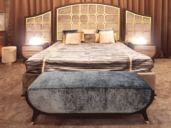 Hotel service concept.  Luxurious bedroom with bed and bedside tables and a mirror. Concept interior, home, comfort, hotel.