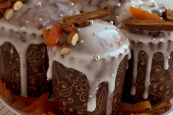 Lezzetli Paskalya pastaları, kurutulmuş muz, portakal kayısı, badem ve küçük zarif şeker gümüşü boncuklarla süslenmiş tabakta birlikte. Geleneksel Ortodoks Paskalya ekmeği - kulich.