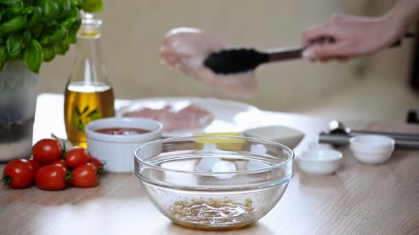 Chef marinating chicken breast in a bowl — Stock Video