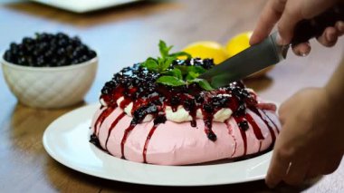 Bir mutfak bıçağı pasta Pavlova kesti. Beze pavlova Pasta krema ile