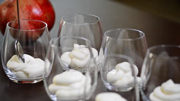 The woman makes the mousse in the glasses — Stock Video