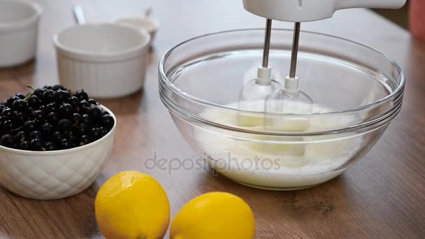 Woman whisking eggs whites with mixer into glass bowl. To make the meringue — Stock Video
