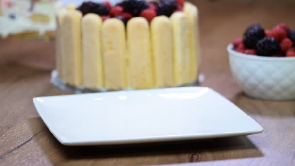 Девочка положила кусок торта Шарлотта на белой тарелке — стоковое видео