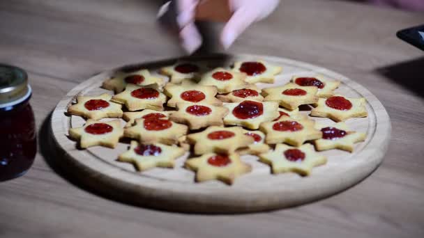 Colocar galletas en forma de estrellas sobre una mesa de madera — Vídeo de stock