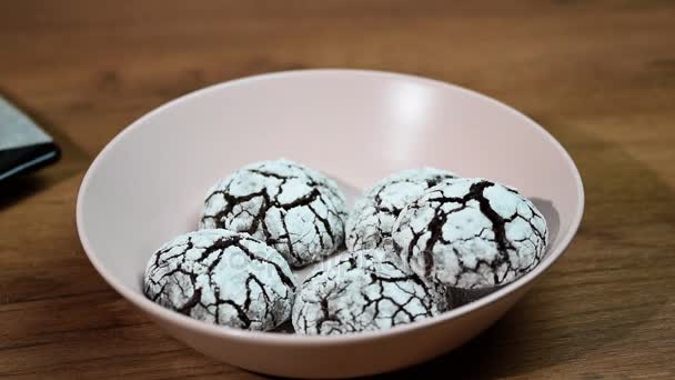 Put in bowl homemade chocolate crinkles cookies powdered sugar — Stock Video