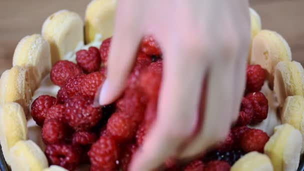 Decorate the cake Charlotte with berries — Stock Video