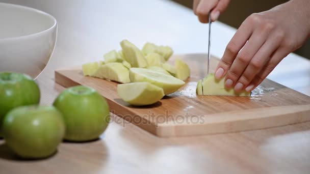 La chica está cortando manzana en la tabla de cortar . — Vídeo de stock