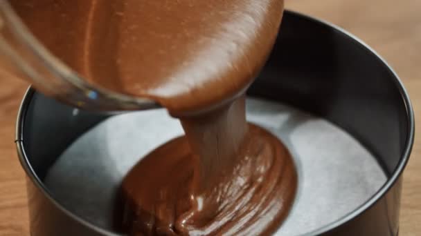 Gieten cake mix in het bakken van tin — Stockvideo