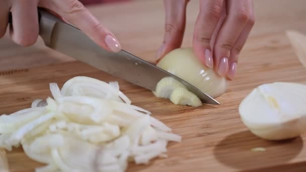 Koch schneidet die Zwiebel in Scheiben. Messer, Schneidebrett, Zwiebel. — Stockvideo