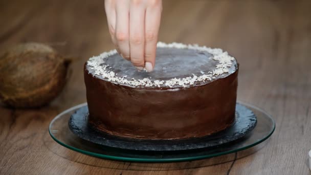 Декорування шоколадного торта з кокосовими пластівцями — стокове відео